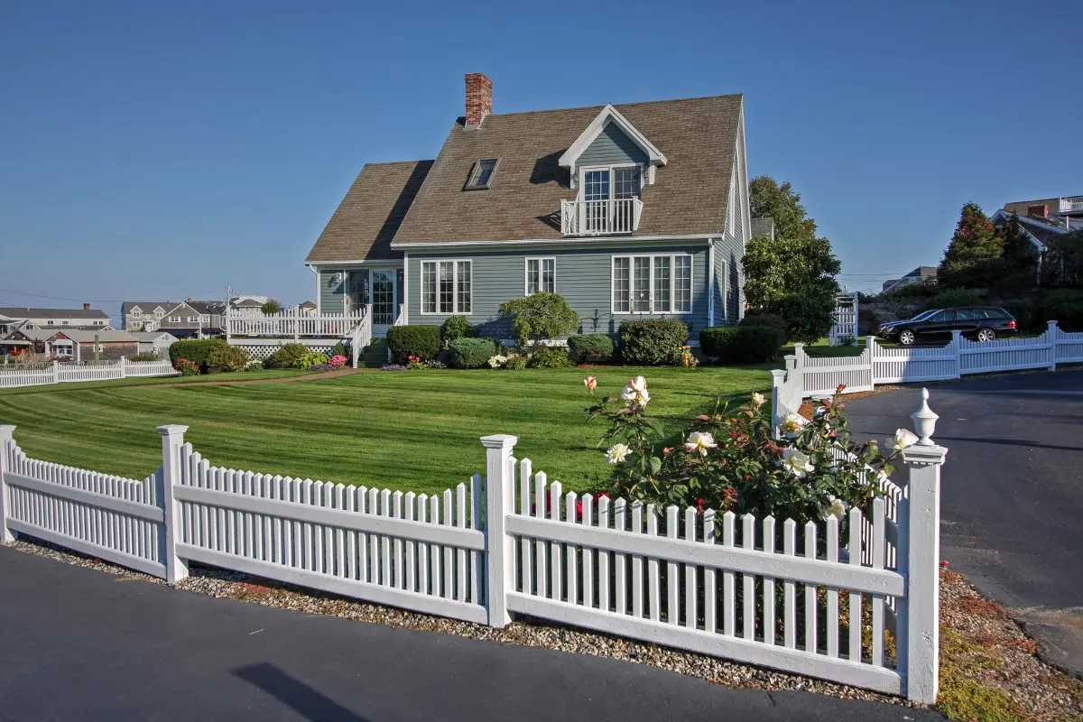 Cape style house with a picket fence