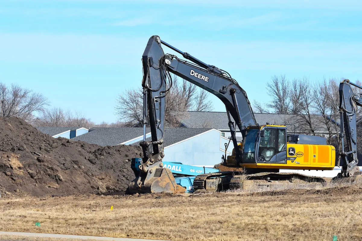 Excavator digging in a residential yard