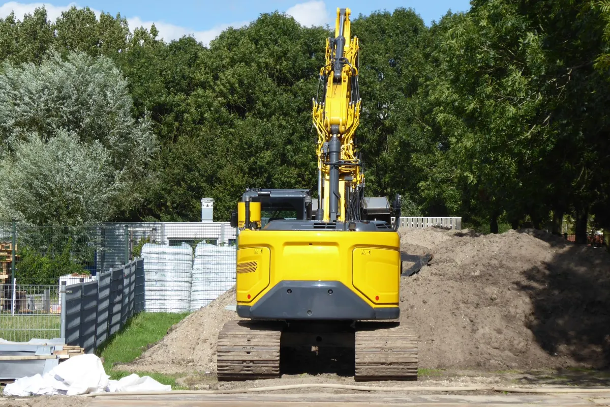 Excavator setting septic treatment units