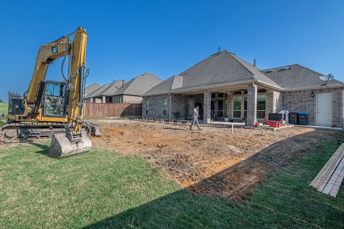 Excavator in a yard installing a new septic system
