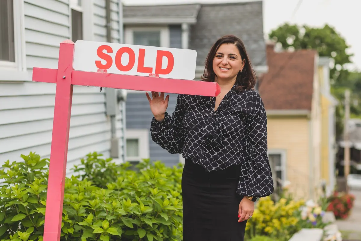 Sold sign outside a clapboard house